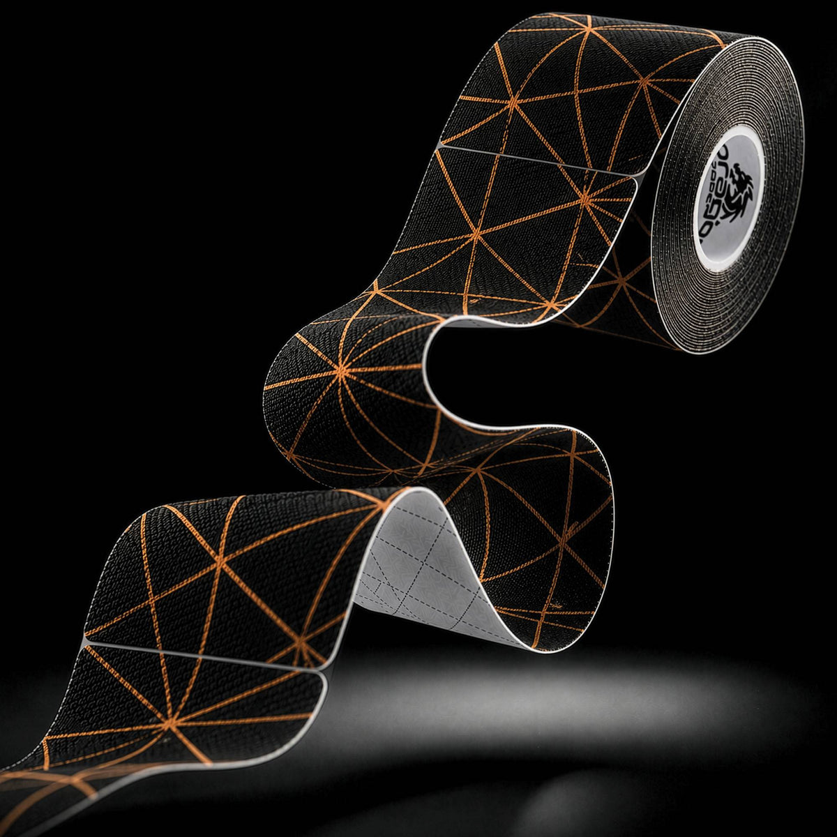 Dragon Tape copper-infused black kinesiology tape roll and strip with geometric pattern.